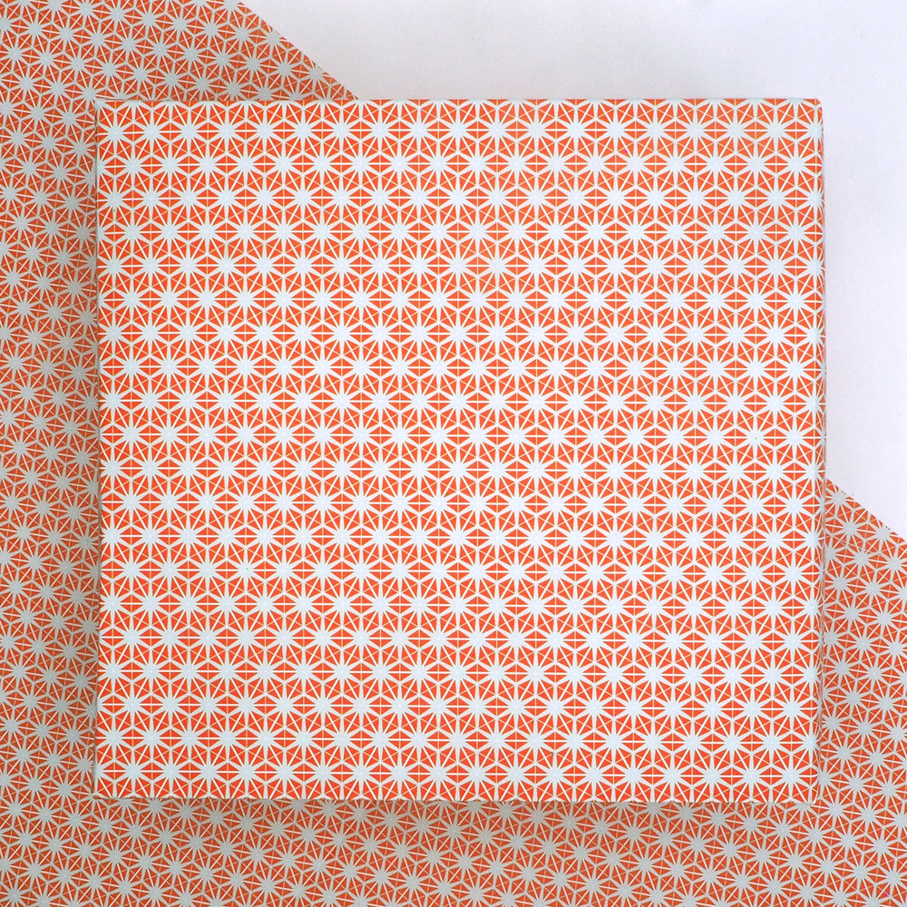recyclable wrapping paper featuring an orange and grey geometric star pattern   on a matching background