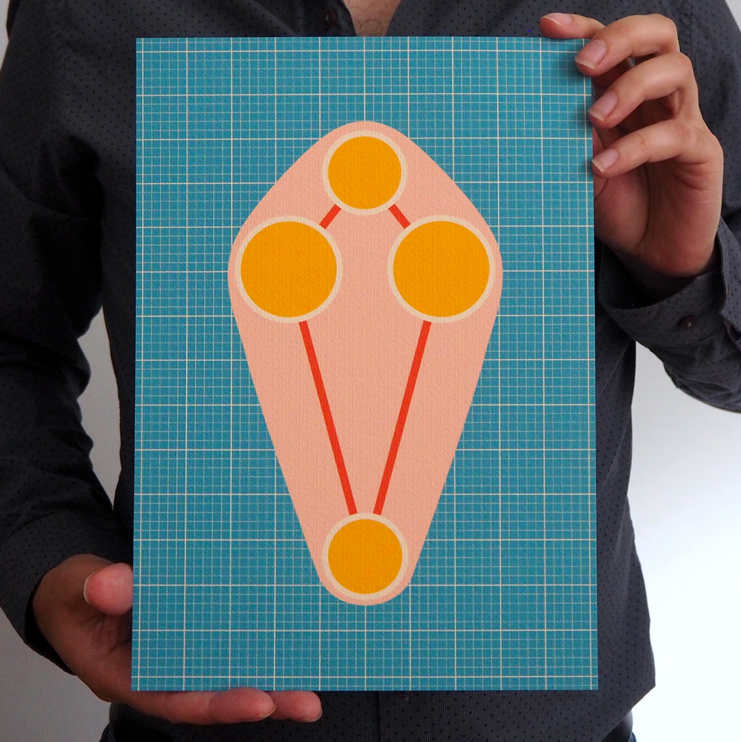 Artist holding an Art Print with a geometric design on a blue grid background