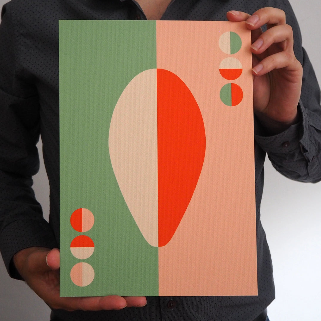 Artist holding a contemporary art print from Bright Stem featuring a colourful geometric graphic design based on a abstract sculpture
