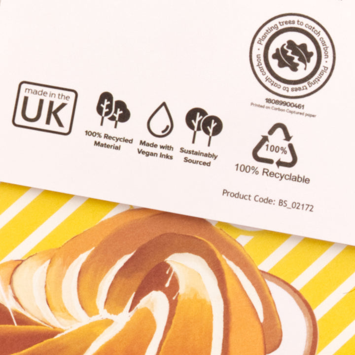 Back of Birthday Card with sustainability labels and a greeting card illustration of a cake on striped yellow lines.
