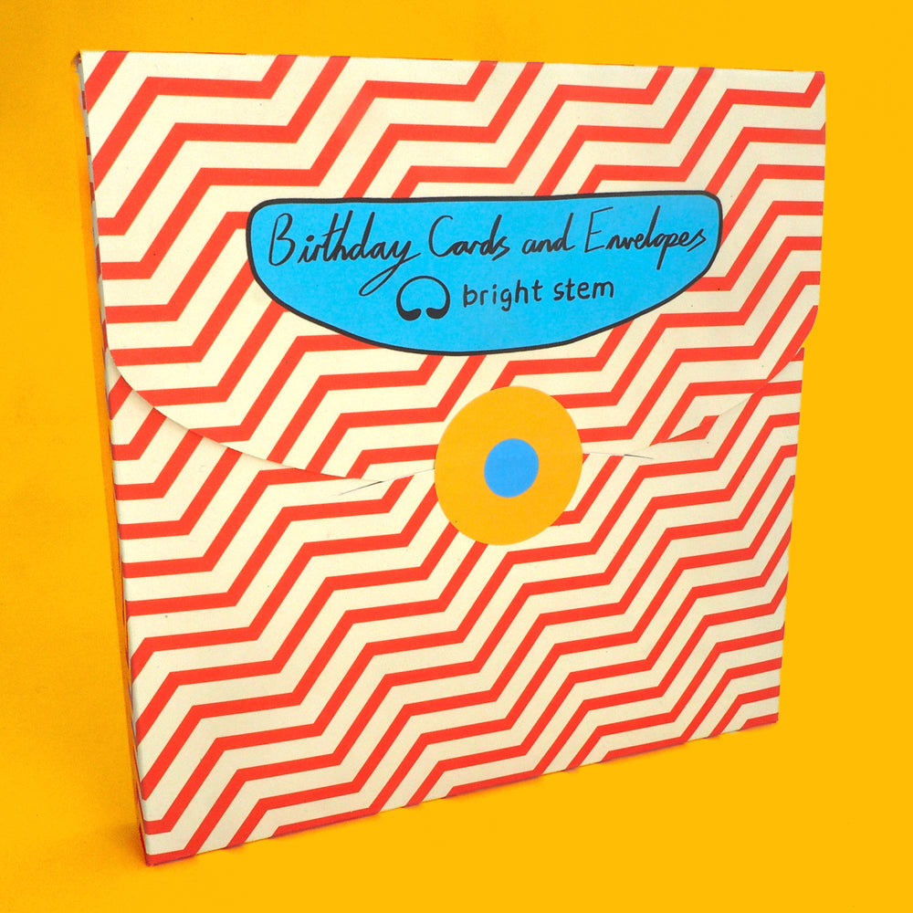 Pack of bright stem birthday cards with red and cream chevron pattern and blue label on a yellow background