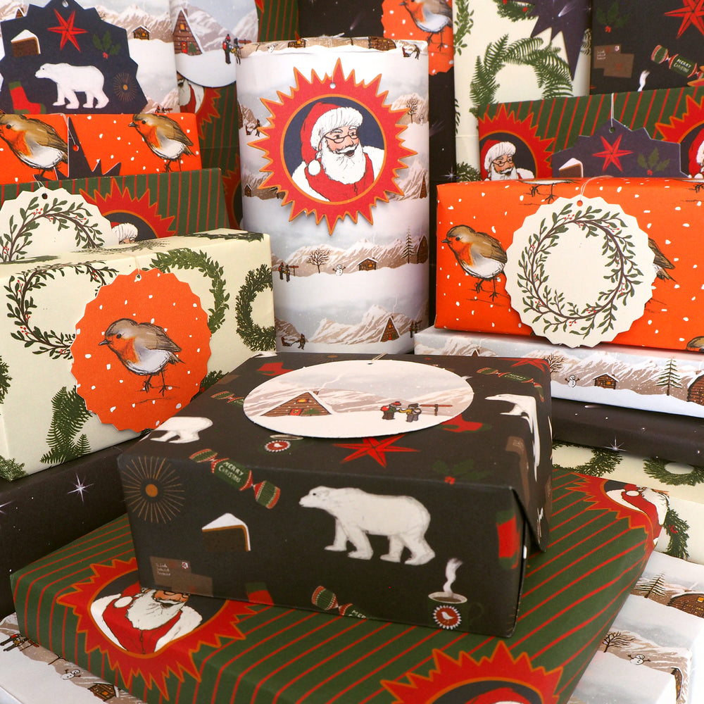 Bright Stem Recyclable Christmas Wrapping Paper  vintage style Illustrated  patterns displayed. Presents wrapped up for xmas. Designs include Santa, robin, winter snowy landscape, polar bear and star, 