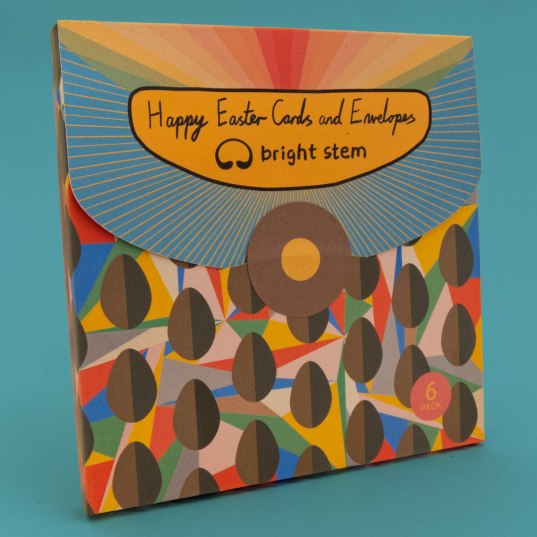 Packaging for Easter cards and envelopes with colourful design and 'bright stem' branding. 6 Pack. Bright Stem Happy Easter Greeting Cards and Envelopes Multipack. Featuring cards with Chocolate Egg and Abstract Pattern. blue background.