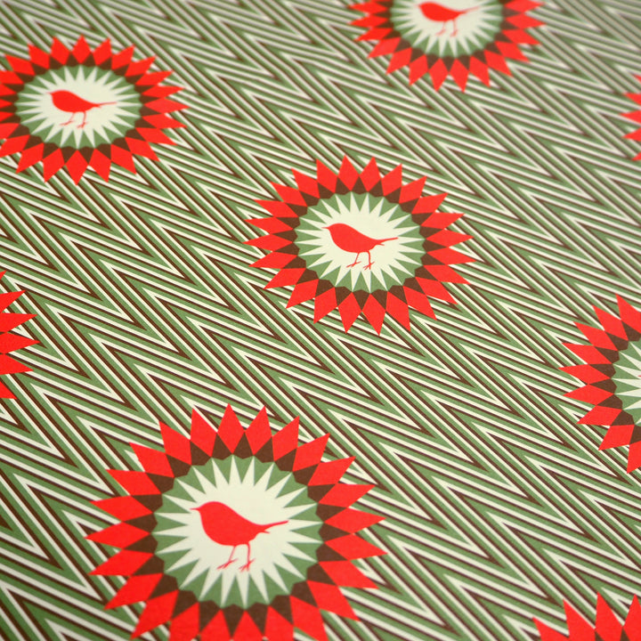 Bright Stem Recyclable Christmas Wrapping Paper Gift Wrap Folded. Close up shot of robin illustration on green zigzag pattern.