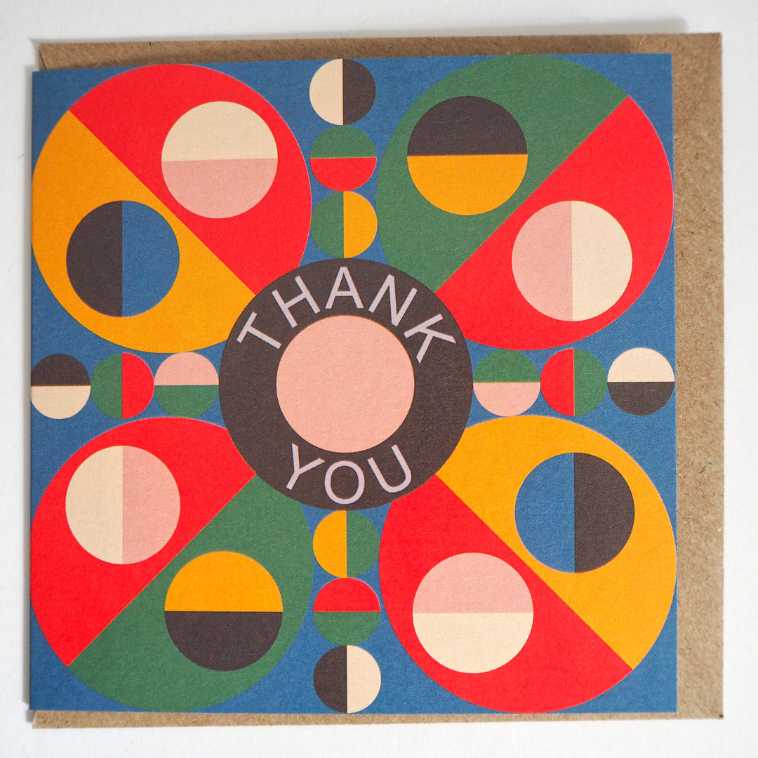 Express your gratitude with these striking modern thank you cards featuring bold geometric designs from Bright Stem. Sold by the Artist. Each set includes 12 cards with three unique patterns (4 of each design) accompanied by matching recycled brown paper envelopes. The vibrant colour palette combines rich reds, blues, greens, and yellows in an eye-catching circular motif, with each design centred around a distinctive 'Thank You' message. Measuring 12 x 12 cm
