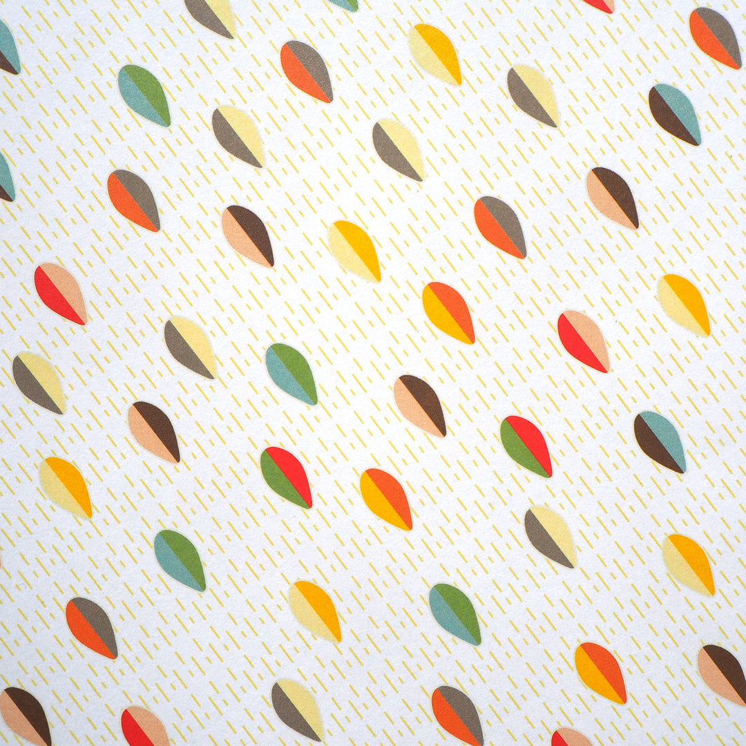 Bright Stem recyclable wrapping paper. Geometric abstract pattern made of multicoloured egg/leaf shapes on a white background with yellow lines. Close up