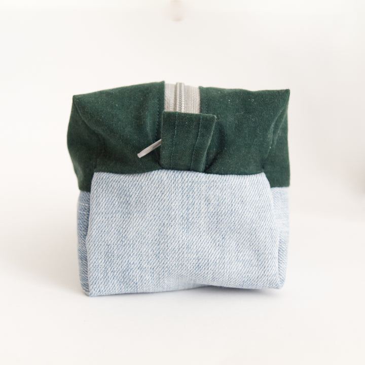 Bright Stem wash bag. Narrow side with hoop. made from green cotton and light blue denim upcycled fabric with a yellow and white cotton inner lining.