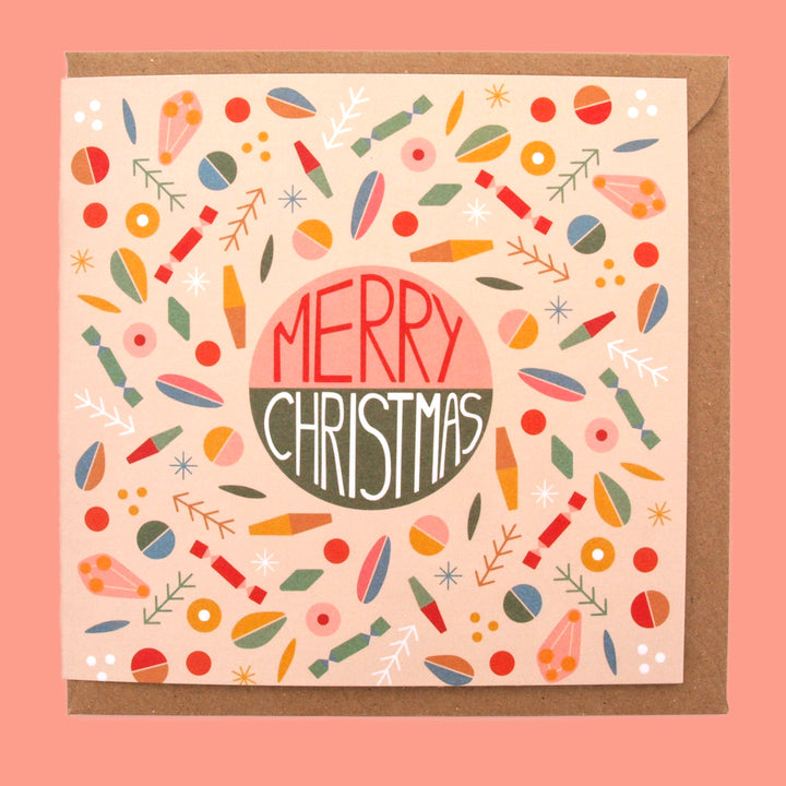 Christmas card with colorful patterns and 'Merry Christmas' text on a pink background