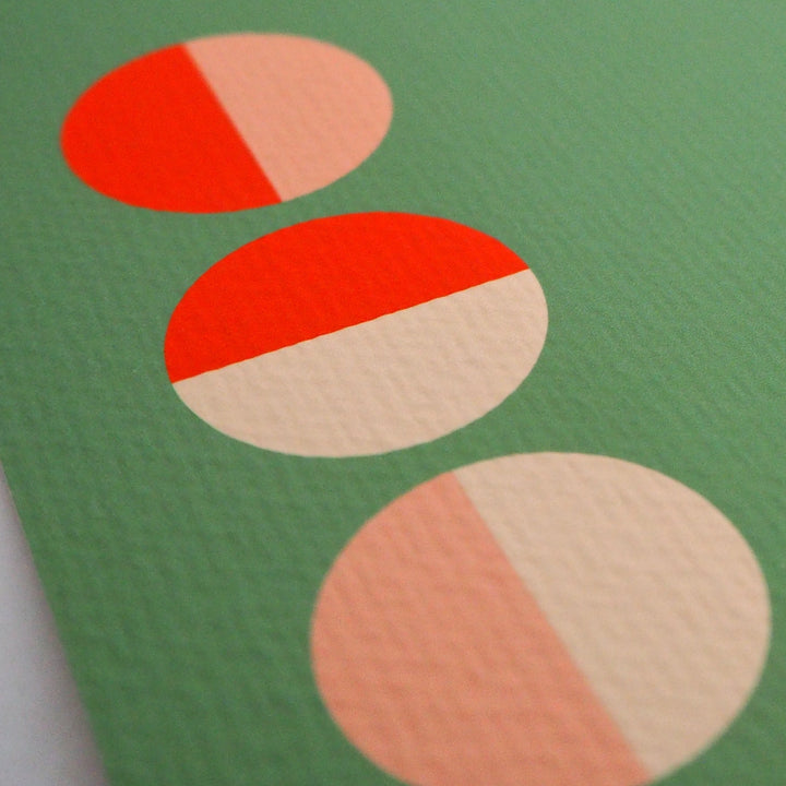 Close-up of Bright Stem contemporary art print. Showing colourful geometric red, pink and cream semi circles with on a green background.  