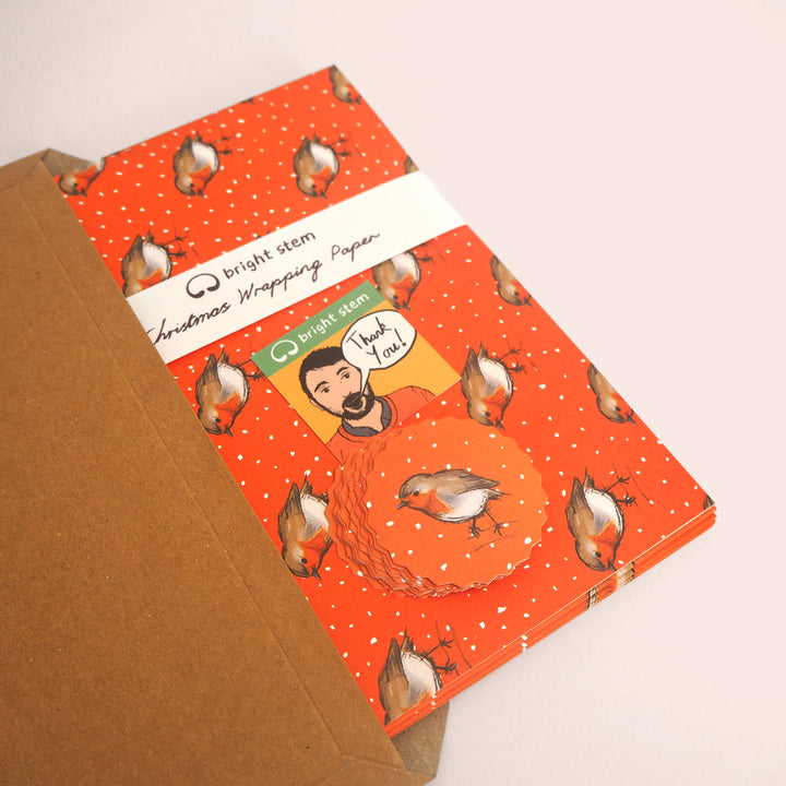 Bright Stem Recyclable Christmas wrapping paper and tags with Robin bird design being packed in brown card folder