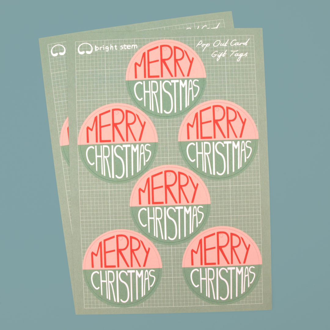 Two Sheets of 6 circular bright stem pop out tags with 'Merry Christmas' written across them. 12 tags in total.