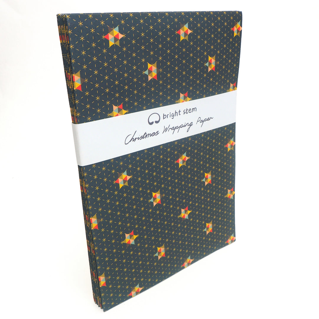 Pack of Christmas wrapping paper with star pattern and 'bright stem' brandied belly band packaging