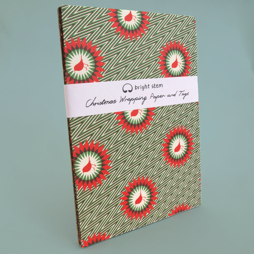 Pack of recyclable Christmas wrapping paper with red and green robin pattern on a light blue background