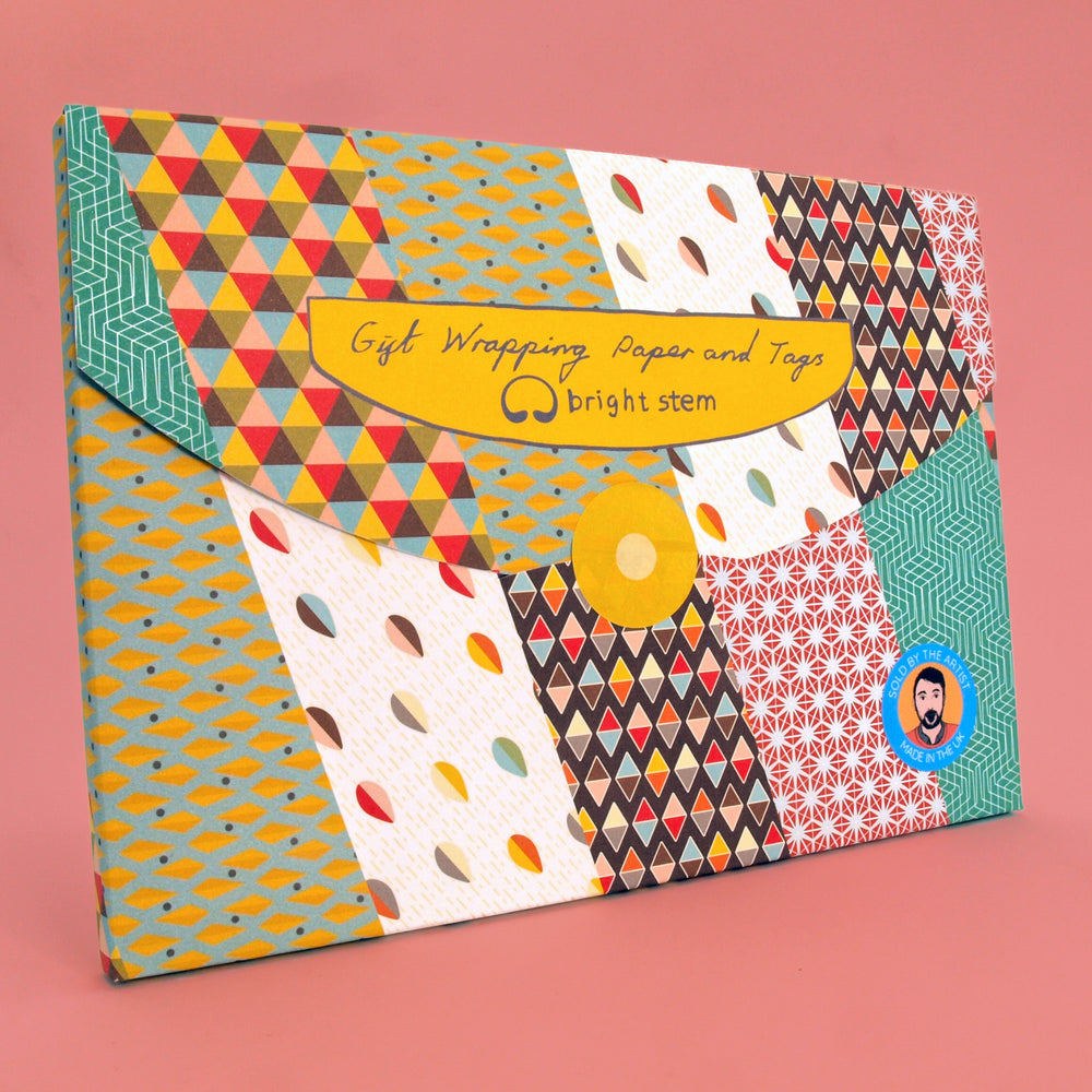 Plastic free packaging of bright stem gift wrapping paper with various geometric patterns on a pink background