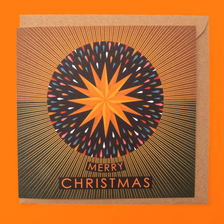 Christmas card with a colourful orange and yellow star design and 'Merry Christmas' text on an orange background