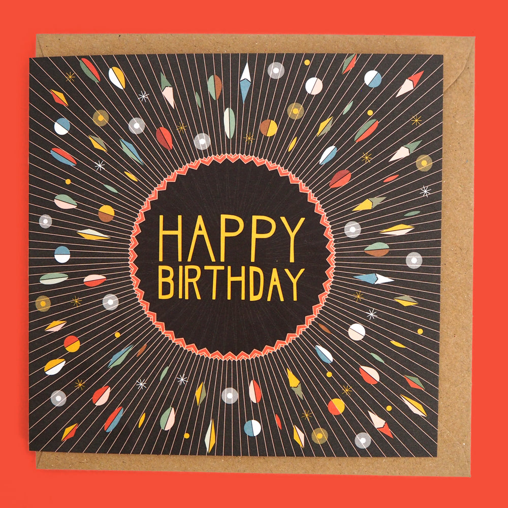 Recyclable greeting card and envelope with 'Happy Birthday' text with a starburst design of abstract shapes. Inspired by Bauhaus and Art Deco Modernist Art movements. on red background