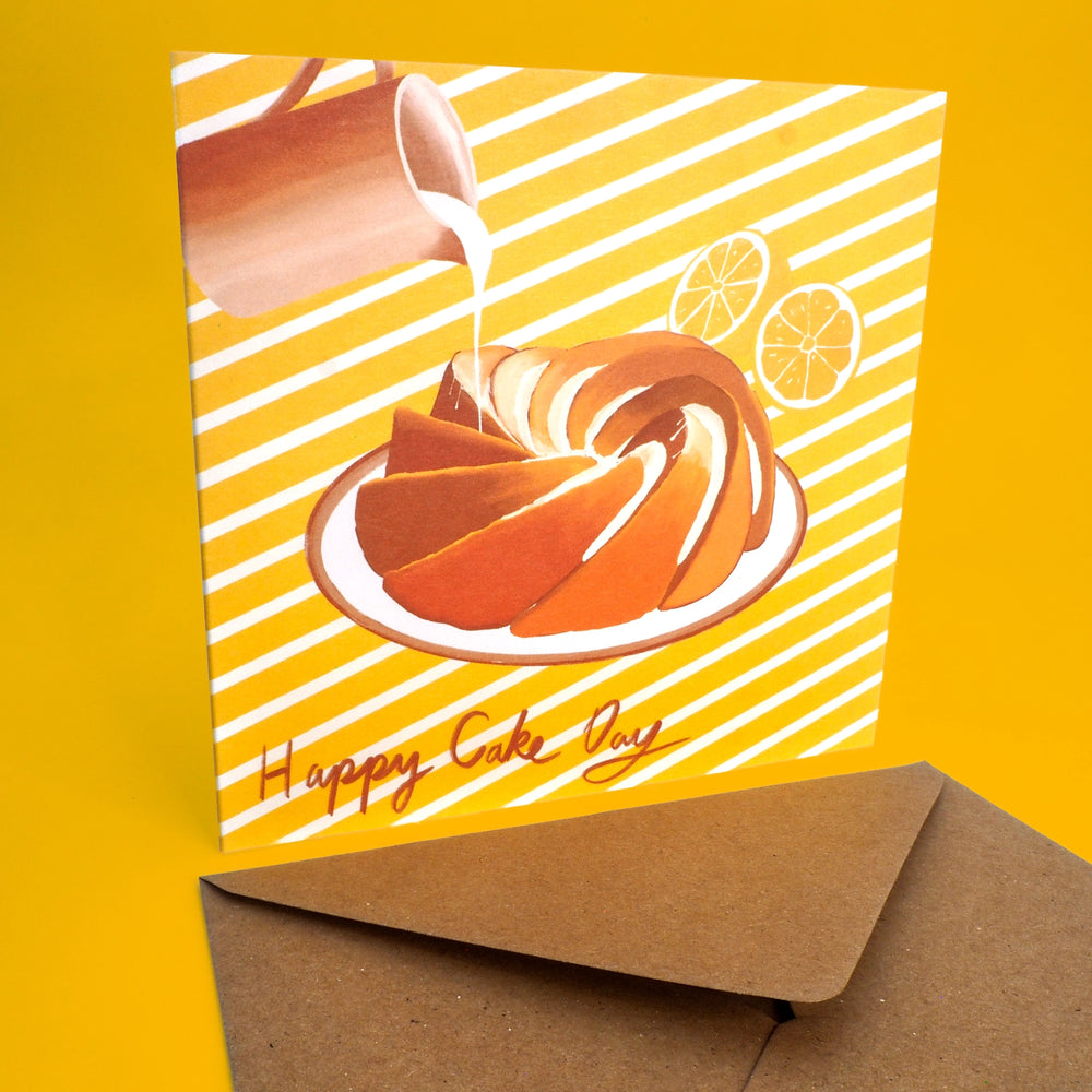 Birthday card with a bundt lemon drizzle cake illustration and 'Happy Cake Day' text on a yellow stripy background