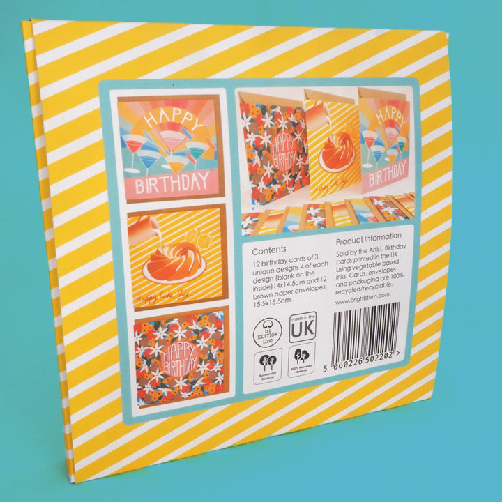 Packaging of birthday cards with colourful designs on a yellow and white striped background.