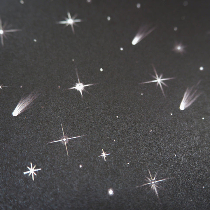 wrapping paper pattern of a Starry night sky with comets and stars on a dark background