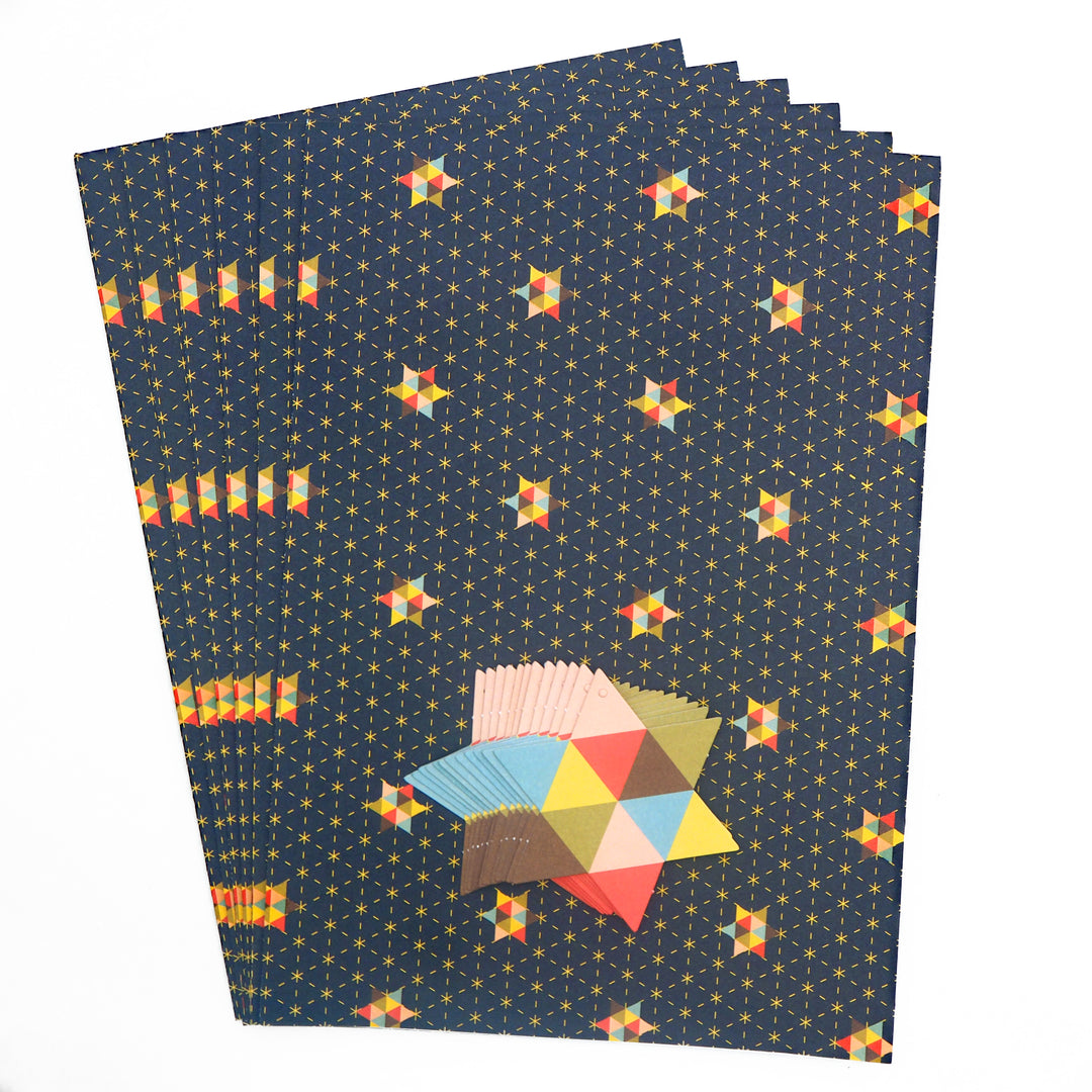 Set of colourful geometric star patterned wrapping paper sheets with star tags on a white background