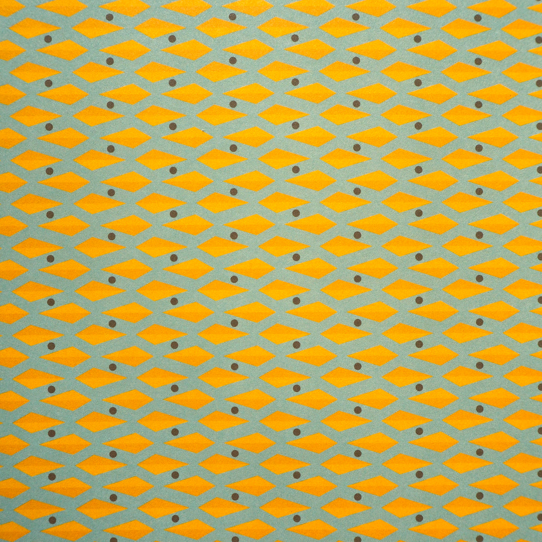 Wrapping paper pattern of geometric yellow diamond shapes on a blue background