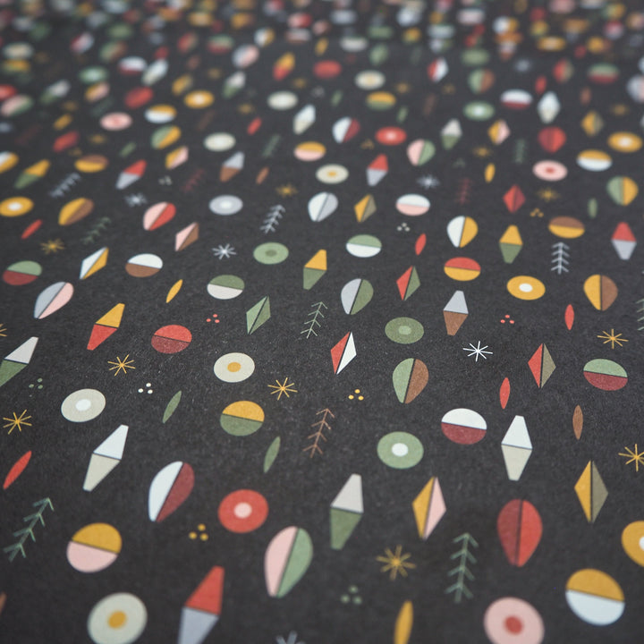 Bright Stem Recyclable Christmas Wrapping Paper Gift Wrap Pattern of Multicoloured Abstract Shapes with Christmas trees and Stars. Close up Shot