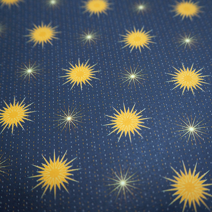Bright Stem Recyclable Christmas Wrapping Paper Gift Wrap. Close up photo of Yellow star pattern on a dark blue background