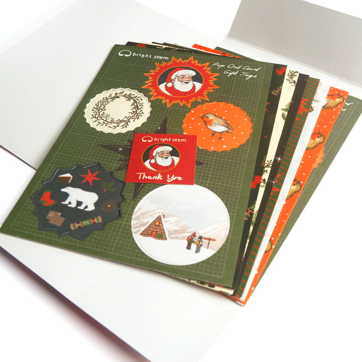 Bright Stem Recyclable Illustrated Christmas Wrapping Paper recycled packaging tags, folded gift wrap and thank you card displayed