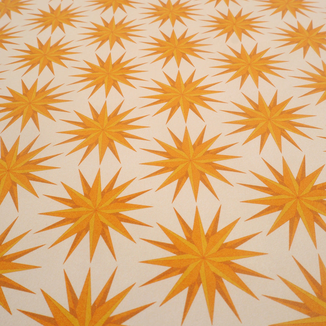 bright stem close up of sheet of Recyclable Gift Wrapping Paper Geometric unique Vintage Style Pattern early 20th century, art deco yellow star design, multicoloured ethically manufactured, made in the uk,