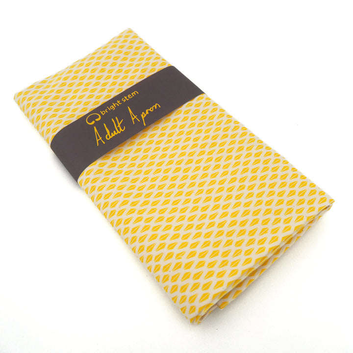 bright stem adult Apron made from organic cotton featuring a yellow triangle pattern, vintage style design folded and wrapped in belly band.