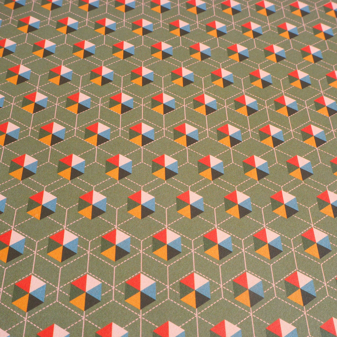 bright stem close up of sheet of Recyclable Gift Wrapping Paper Geometric unique multicoloured triangledesign on grey background Vintage Style Pattern early 20th century, 50’s, modernist, festival of Britain design, multicoloured ethically manufactured, made in the uk,